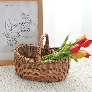 Close-up of a handmade willow picnic basket with a single handle and decorative tulips