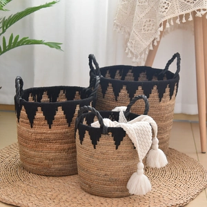 Three-piece handmade woven storage basket set with black fringe and woven rope handles