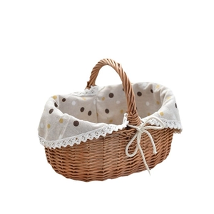 Handwoven willow picnic basket with beige polka dot lining and white lace trim detail