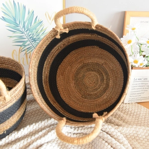 Top view of large woven storage basket with natural brown fibers and black stripes
