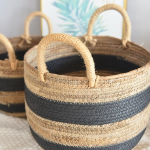 Detail of hand-woven seagrass basket featuring natural textures and bicolor stripes