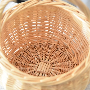 Close-up of the intricate weave and sturdy bottom of the natural wicker storage basket