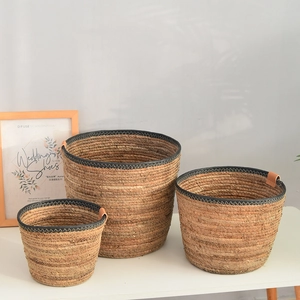 Detailed macro view of Nordic woven baskets set featuring natural texture and leather accents