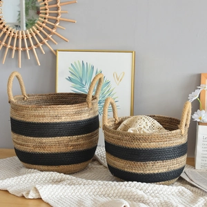 Detail of handwoven seagrass storage baskets with black striped patterns and handles