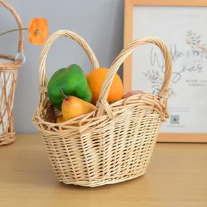 Detail view of woven storage basket with sturdy handles filled with artificial fruit