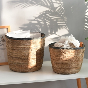 Detail view of woven storage baskets set with black trim for home organization