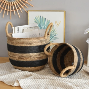 Detailed macro view of woven rattan storage baskets with black stripes and sturdy handles