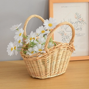 Detailed view of handmade woven willow storage basket with sturdy double handles and flowers
