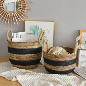 Detail of hand-woven storage baskets featuring black stripes and rustic hemp rope handles