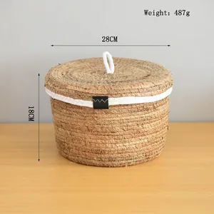 Macro detail of hand-woven round storage basket with lid and white rope handle accents