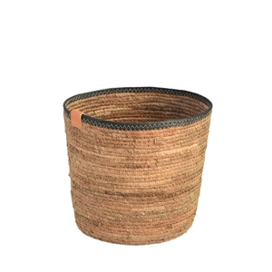 Nordic woven straw storage basket with black trim edge and leather label details
