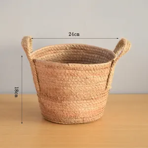 Detail view of woven straw storage basket showing 24cm diameter and 18cm height dimensions