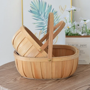 Set of two handmade oval wood chip woven baskets with handles for picnic or storage