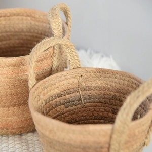Close-up of hand-woven seagrass basket with sturdy rope handles and natural texture