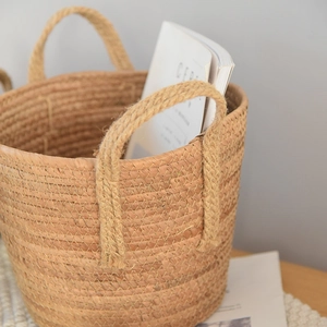Close-up of natural seagrass woven basket with reinforced rope handles for home storage