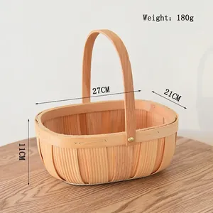 Detailed view of handmade oval wooden woven basket with sturdy handle and rural style