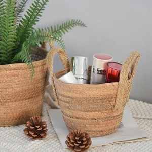 Detail of hand-woven seagrass storage basket with handles for home organization