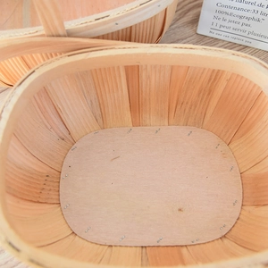 Close-up of handmade oval woven wooden basket showing natural wood grain and texture