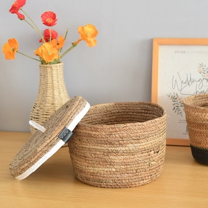 Close-up of handmade woven storage basket with lid showing natural seagrass texture