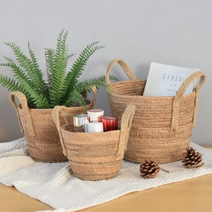 Set of three Nordic handwoven seagrass storage baskets with handles for home decor
