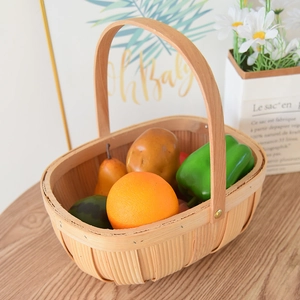 Handcrafted oval woven wood picnic basket with handles for fruits and storage