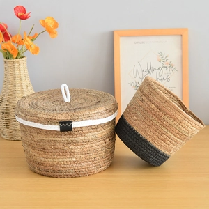 Detailed close-up of handmade woven seagrass storage baskets with natural and black texture