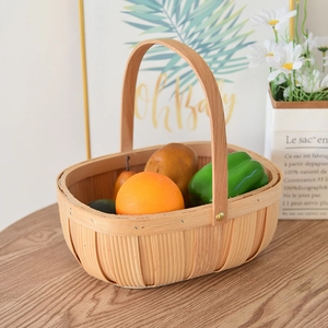 Detail showing the woven wood texture of the picnic basket filled with fresh produce