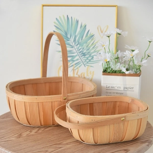 Close-up of hand-woven wooden fruit baskets with sturdy handles in two sizes