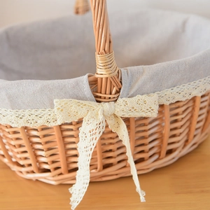 Detailed macro view of natural woven willow basket with grey fabric and lace trim bow