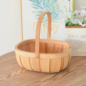 Close-up of hand-woven wood chip picnic basket with metal rivet and handle detail