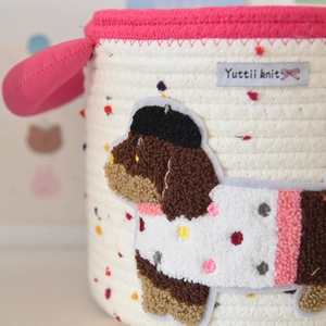 Macro shot of cotton rope storage basket featuring detailed puppy embroidery and textured weave
