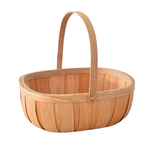 Handwoven wood chip basket with handle and gold rivets for fruit storage and picnic