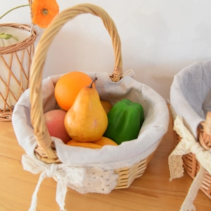 Detailed close-up of handmade wicker basket with white lace liner and fresh fruit decor