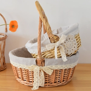 Macro detail of two woven wicker flower baskets with lace lining and bow decorations