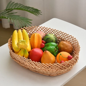 Close-up of a woven wicker fruit basket filled with realistic artificial vegetables and fruits