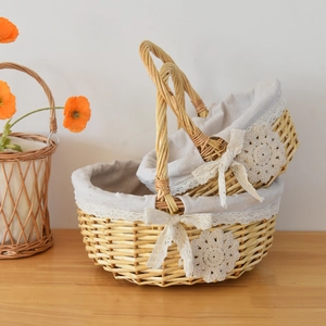 Handwoven wicker flower baskets with lace lining and ribbon bows in a natural wood finish