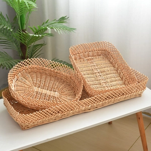 Close-up of woven willow storage baskets with decorative scalloped edges on a table