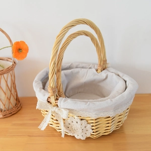 Detail of handmade woven baskets with white lace lining and delicate floral accents