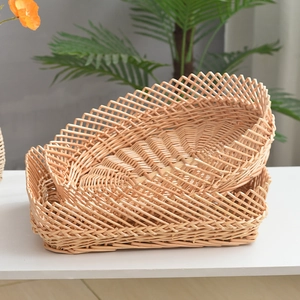 Detail of two-piece woven willow storage baskets with decorative scalloped wavy edges