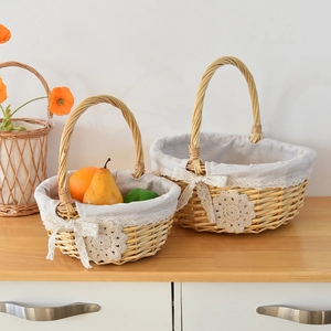 Detail of two-piece woven wicker storage baskets with grey lining and lace trim decoration
