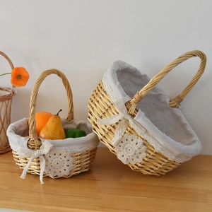 Detail of two-piece handwoven wicker baskets with lace fabric lining and bow decoration