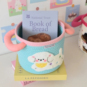Detail of blue woven storage basket with pink trim and cute puppy patch for desktop
