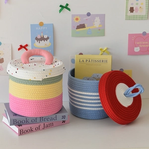 Detailed macro view of woven cotton rope storage baskets with colorful stripes and lids