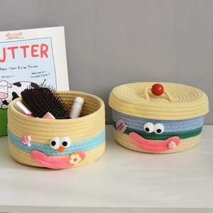 Detailed view of woven cotton rope storage baskets with cute 3D cartoon facial expressions