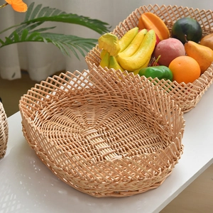 Macro detail of hand-woven wicker storage basket featuring unique wavy edges for home fruit display