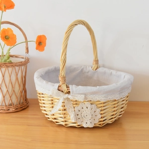 Close-up of woven wicker basket featuring elegant lace lining and decorative floral bow