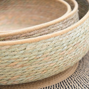 Detail of hand-woven natural seagrass round pet nest set with durable fabric edges