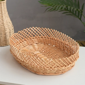 Detail of hand-woven wicker basket showing oval cross-braid pattern and natural texture