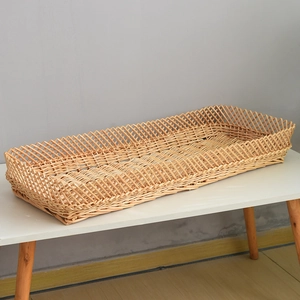 Detail of handwoven rectangular wicker tray with intricate diamond lattice weaving patterns