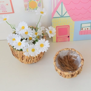 Close-up of natural woven grass planter featuring a waterproof transparent plastic lining